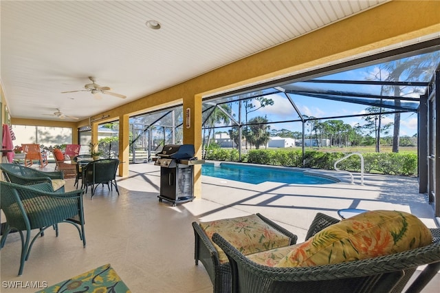 view of pool with a patio, glass enclosure, ceiling fan, and a grill