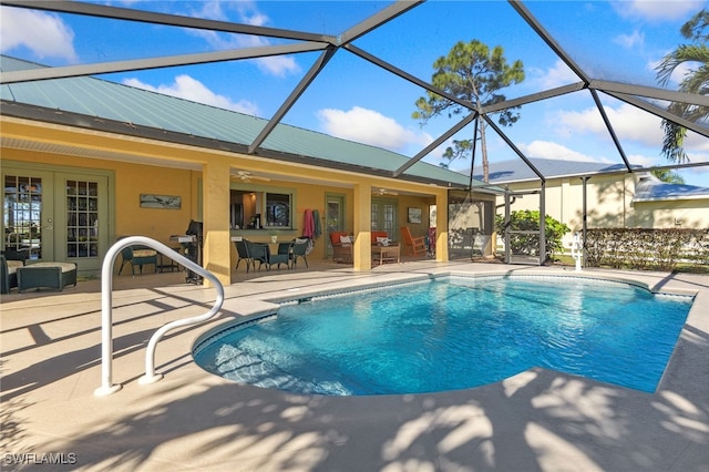 view of swimming pool with a lanai, a patio area, and ceiling fan