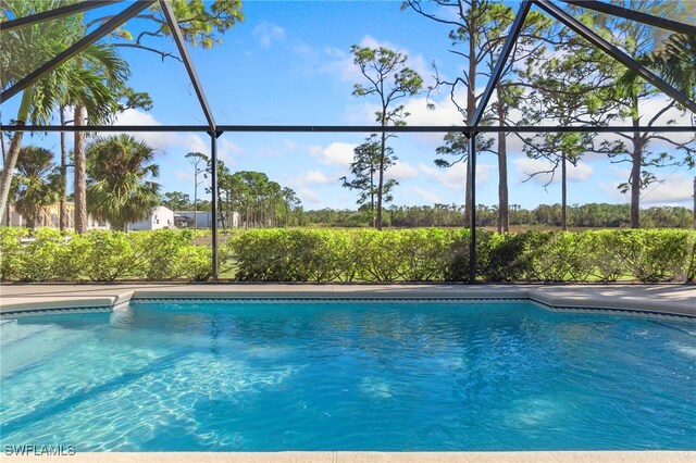 view of swimming pool with a lanai