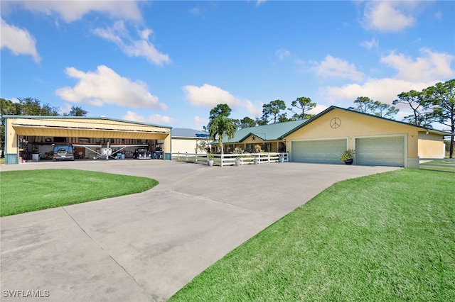 single story home with a front yard and a garage