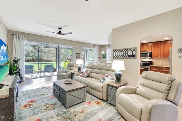 tiled living room with ceiling fan