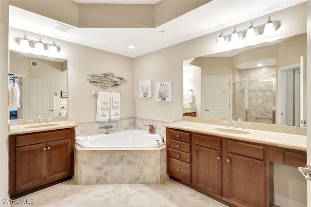 bathroom with tile patterned floors, vanity, and separate shower and tub