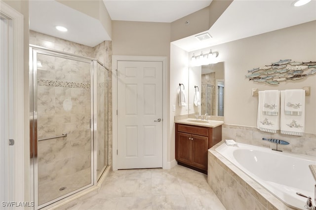 bathroom with plus walk in shower, vanity, and tile patterned floors