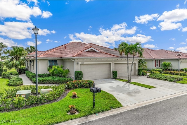 view of front facade with a front yard, driveway, an attached garage, stucco siding, and a tile roof