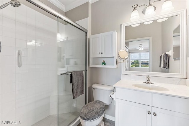 full bath with vanity, a shower stall, toilet, and crown molding