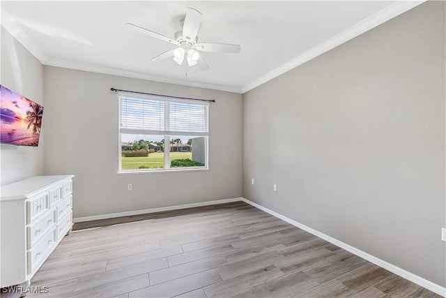 unfurnished room featuring crown molding, light wood-style flooring, and baseboards