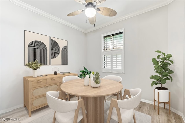 dining area with crown molding, a ceiling fan, baseboards, and light wood finished floors