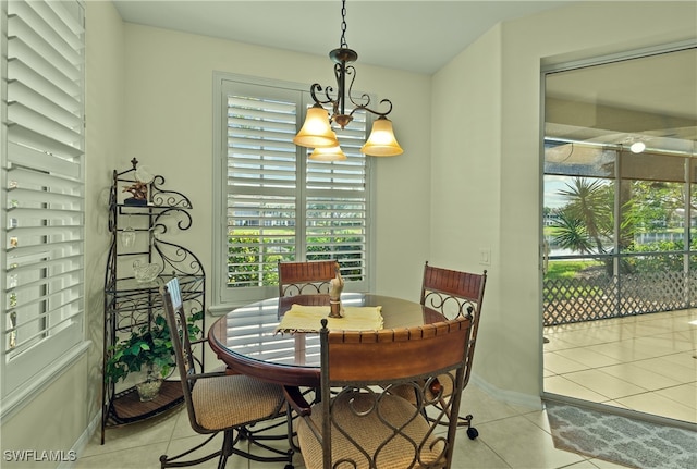 tiled dining area with an inviting chandelier