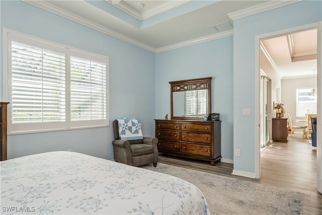 bedroom featuring hardwood / wood-style flooring and crown molding