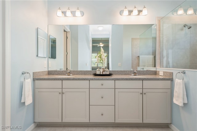 bathroom featuring vanity and tiled shower