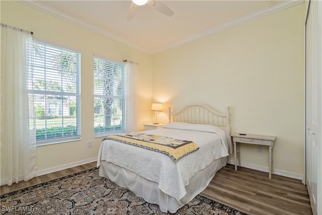 bedroom featuring multiple windows, ceiling fan, and hardwood / wood-style flooring