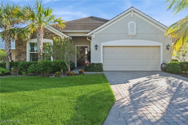 view of front of home with a front lawn and a garage