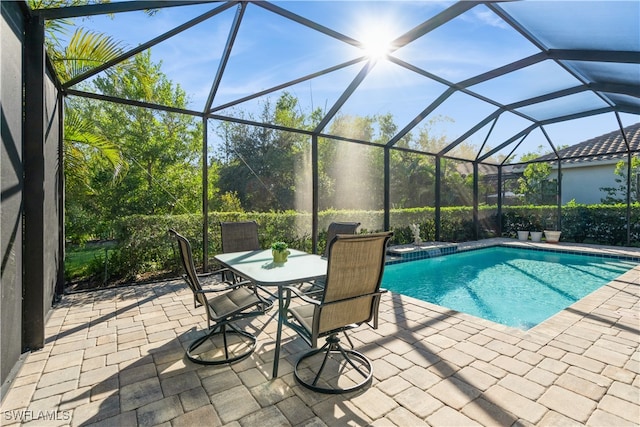 view of swimming pool with a lanai and a patio area