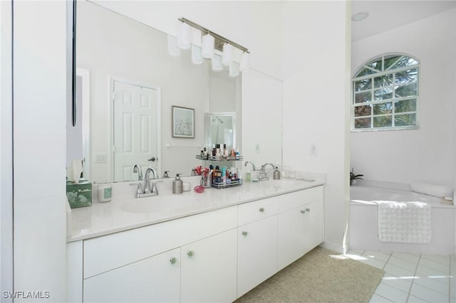 bathroom with tile patterned floors, vanity, and a tub to relax in