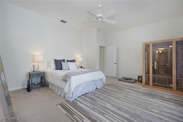 bedroom with ceiling fan and light colored carpet