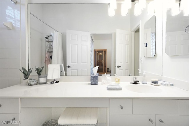 bathroom featuring vanity and curtained shower