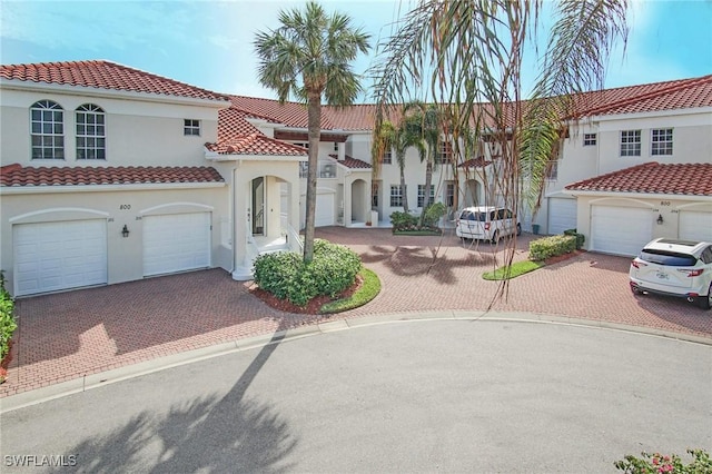 mediterranean / spanish-style home with a garage