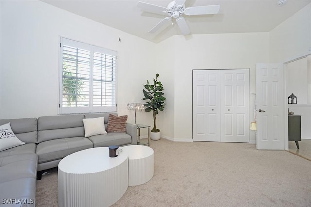 living room featuring light colored carpet, vaulted ceiling, and ceiling fan