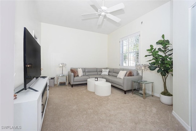 carpeted living room with ceiling fan