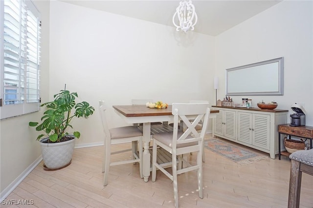 dining space featuring a chandelier and light hardwood / wood-style flooring