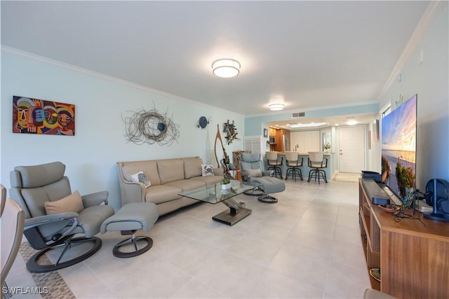 living room with light tile patterned floors and crown molding