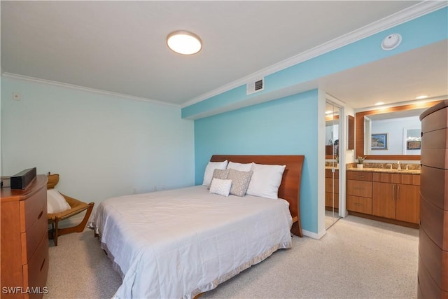 carpeted bedroom with sink, ensuite bath, and ornamental molding