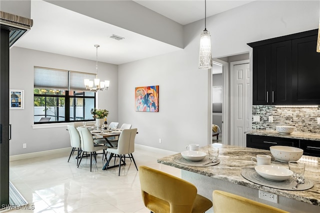 dining space with a notable chandelier