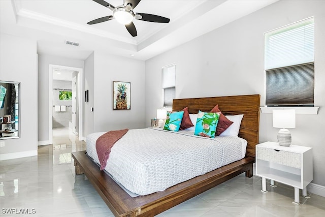 bedroom with a raised ceiling, ceiling fan, and ornamental molding