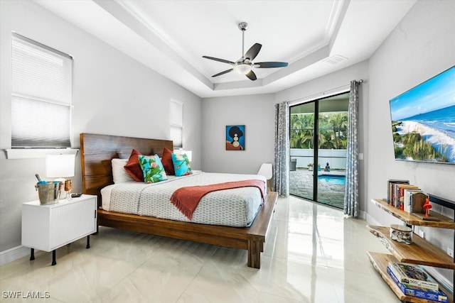 tiled bedroom with ceiling fan, a raised ceiling, crown molding, and access to outside