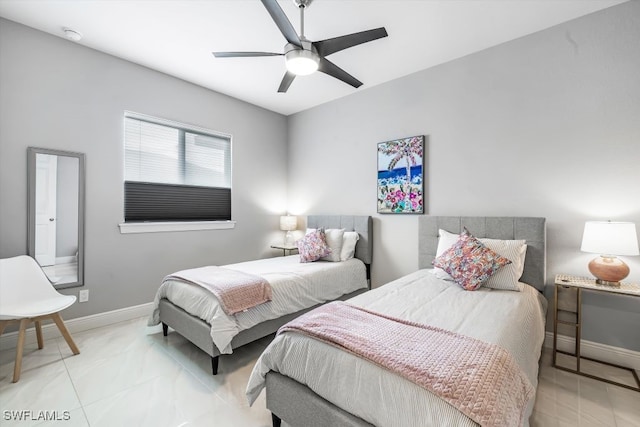 bedroom with ceiling fan and light tile patterned flooring