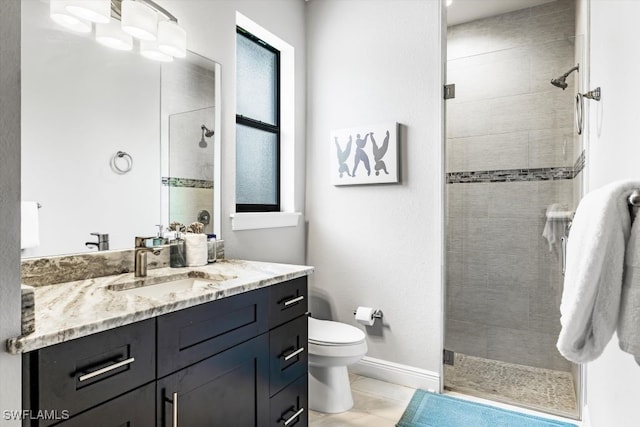 bathroom with tile patterned flooring, vanity, an enclosed shower, and toilet