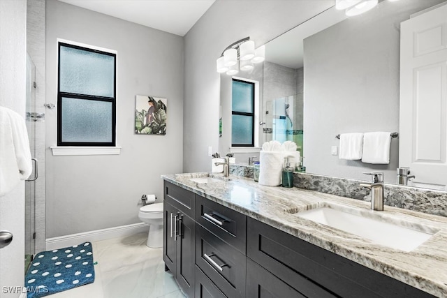 bathroom featuring toilet, vanity, a healthy amount of sunlight, and walk in shower