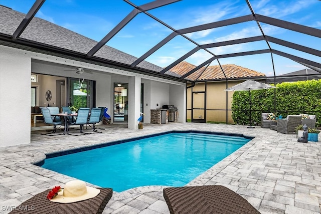 view of pool with ceiling fan, area for grilling, a patio area, and an outdoor hangout area