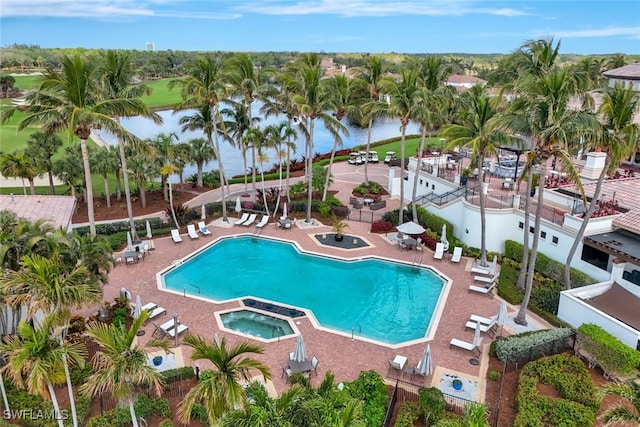 view of pool with a patio area and a water view