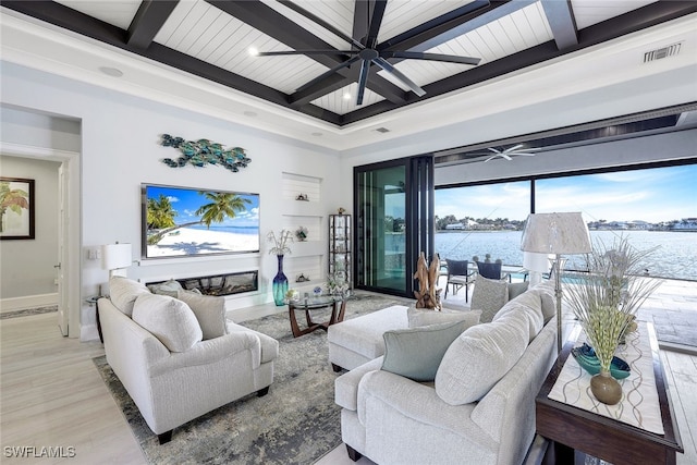 living room featuring beamed ceiling, a water view, light hardwood / wood-style floors, and coffered ceiling