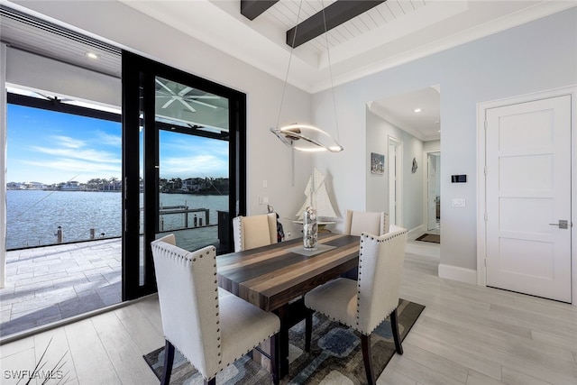 dining space featuring wooden ceiling, beamed ceiling, a water view, and light hardwood / wood-style floors