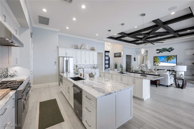 kitchen featuring coffered ceiling, a spacious island, light hardwood / wood-style floors, white cabinetry, and hanging light fixtures