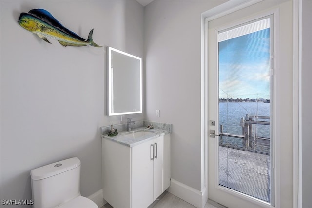 bathroom featuring vanity, toilet, and a water view