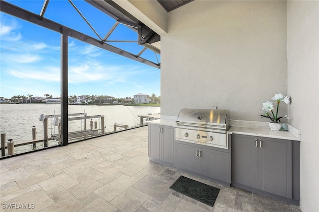 view of patio with a dock, a water view, area for grilling, and a grill