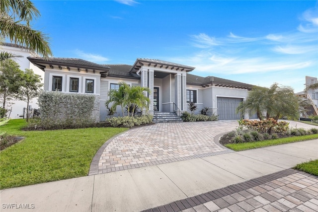 view of front of house with a front lawn and a garage