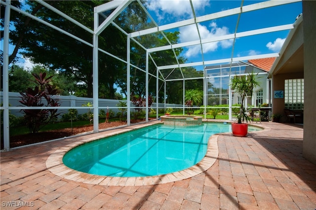 view of pool featuring an in ground hot tub, a patio, and a lanai