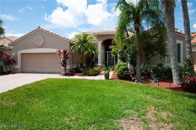 mediterranean / spanish-style home with a garage and a front lawn