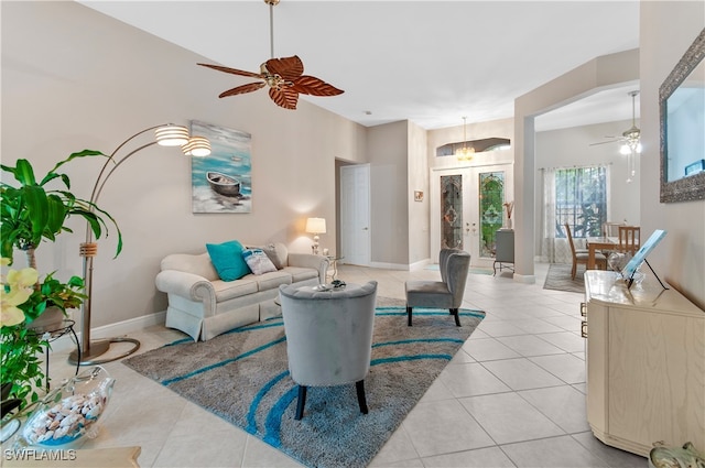 living room featuring french doors, ceiling fan, and light tile patterned flooring