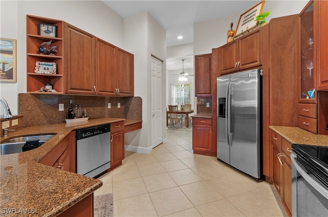 kitchen featuring decorative backsplash, dark stone countertops, sink, and appliances with stainless steel finishes