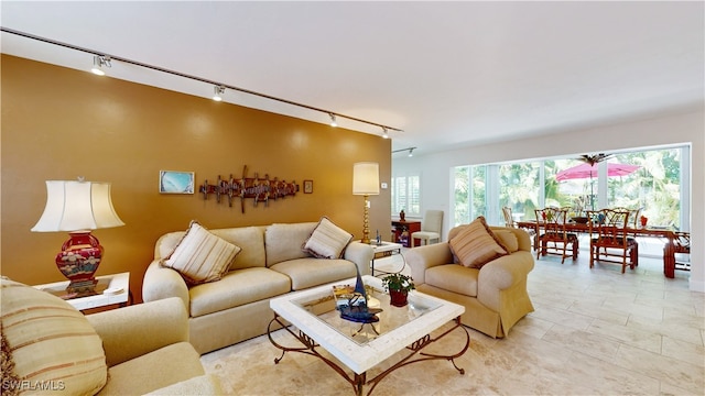 living room with light tile patterned floors and rail lighting