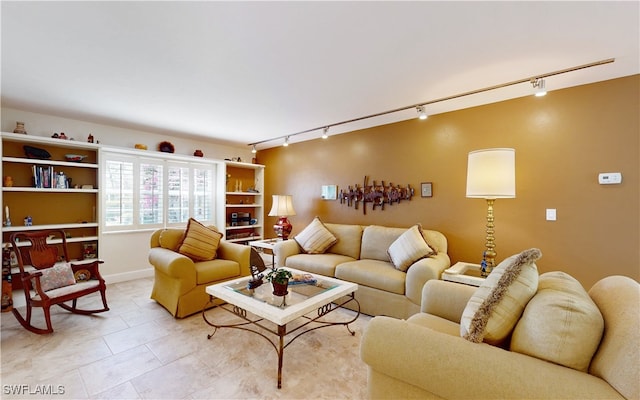 tiled living room featuring rail lighting