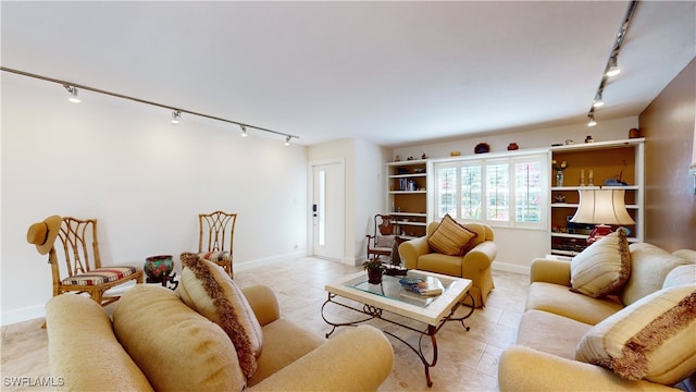 living room featuring light tile patterned floors and rail lighting