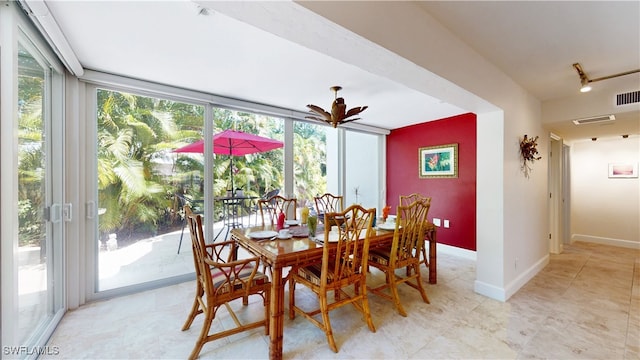 dining room with floor to ceiling windows, plenty of natural light, and track lighting