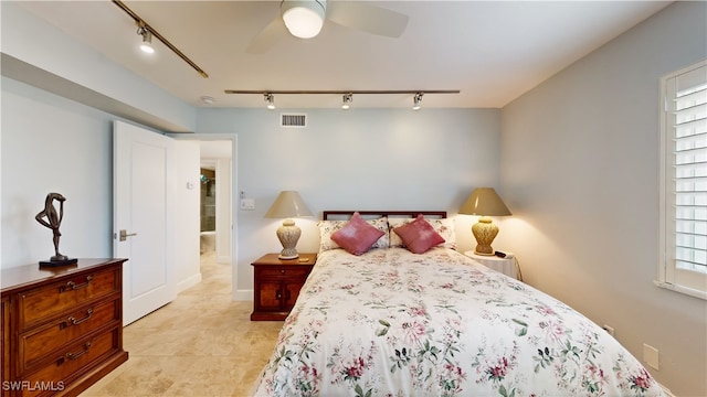 bedroom with rail lighting and ceiling fan