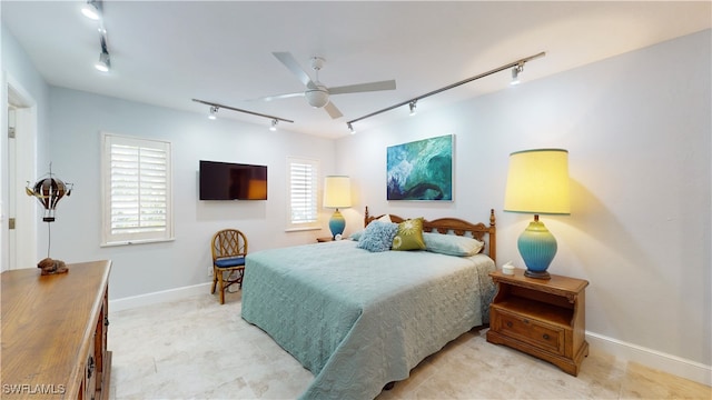 bedroom with track lighting and ceiling fan